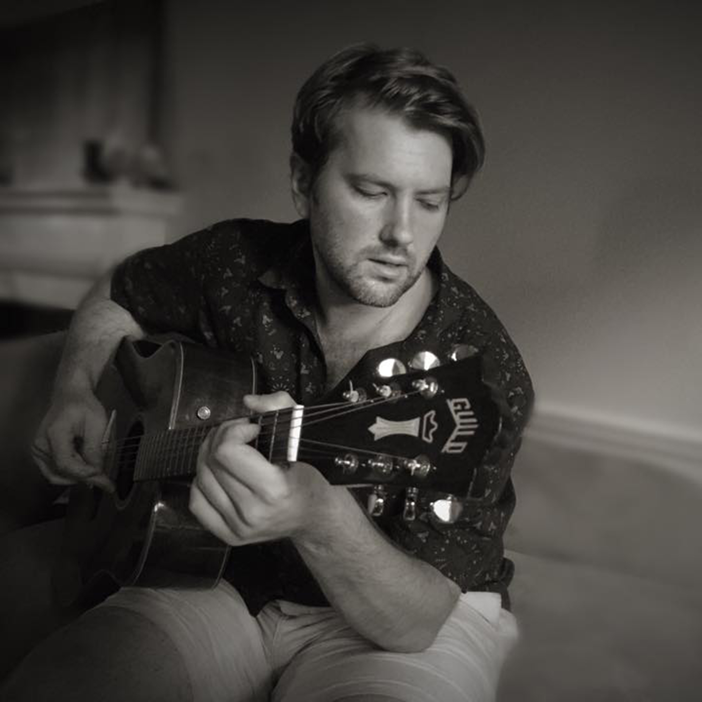 Brandon Keeley playing acoustic guitar